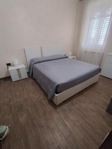 a bedroom with a bed and two night stands at B&B Vista Mare in Palmi