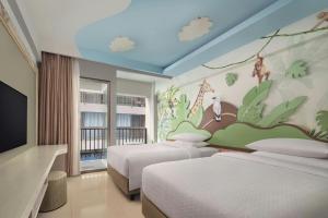 Postel nebo postele na pokoji v ubytování Four Points by Sheraton Bali, Kuta