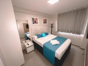a small bedroom with two beds and a window at Helbor My Way - Compactos de luxo in Fortaleza +210 photos