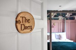 a wooden sign that reads the dryer hanging on a wall at Carnbore House BnB in Bushmills