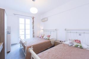 a bedroom with two beds and a window at George Studios in Naxos Chora