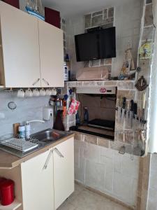 a kitchen with a sink and a stove at Magi Sunrise in Balchik