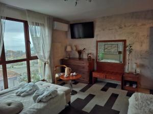 a bedroom with a bed and a dresser and a mirror at Magi Sunrise in Balchik