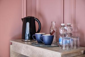 a shelf with glass bottles and cups on it at Carnbore House BnB in Bushmills