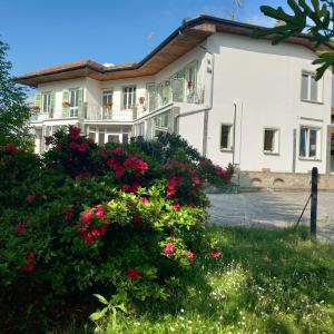 a large white building with flowers in front of it at Residenza il Rododendro in Candelo