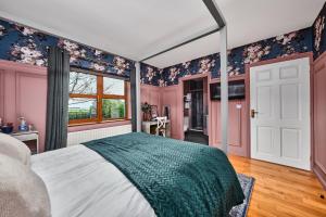 a bedroom with pink and blue walls and a bed at Carnbore House BnB in Bushmills
