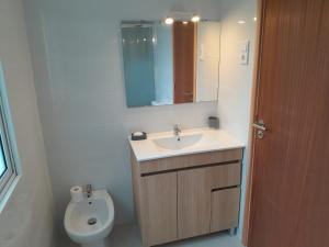 a bathroom with a sink and a toilet at Quinta do Sossego in Pico da Pedra +37 photos