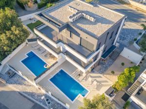 an aerial view of a house with two swimming pools at Black Diamond in Novalja