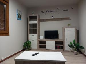 a living room with a tv and a coffee table at Casa do Carpinteiro in Brocos +6 photos