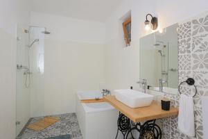 a white bathroom with a sink and a shower at Fekete Gólya Fogadó Gemenc in Szekszárd +19 photos