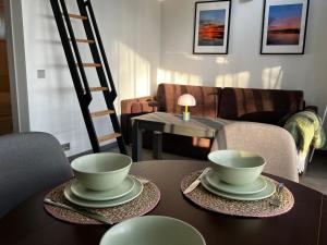 a living room with a table with two bowls on it at Atpūtas kempings Ozoli in Usmenieki