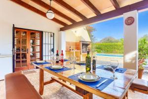 a dining room with a table with wine glasses at Villa Vinya Maria by Villa Plus in El Port