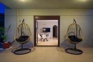 two chairs in a room with a table in the background at Atalaya Villa in Stalís