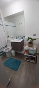a bathroom with a tub and a toilet and a sink at Departamento nuevo 2D 1B cerca del Mall in Puerto Montt