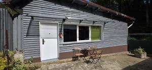 ein kleines Haus mit einem Tisch und Stühlen im Freien in der Unterkunft Studio dorința in Deva