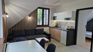 a living room with a couch and a kitchen at Domek Nadmorski przy plaży Ustka in Ustka +18 photos