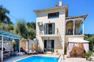 a villa with a swimming pool in front of a house at Villa Olga Katouna by Villa Plus in Katouna