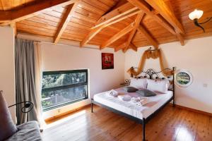 a bedroom with a bed and a large window at Villa Olga Katouna by Villa Plus in Katouna +20 photos
