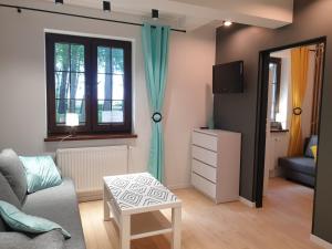 a living room with a couch and a mirror at Domek Nadmorski przy plaży Ustka in Ustka