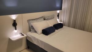 Ένα ή περισσότερα κρεβάτια σε δωμάτιο στο Apartamento Horizonte Azul Vista Serra +27 φωτογραφίες
