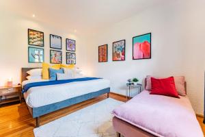 a bedroom with two beds and paintings on the wall at Bright and Secure Condo near Chapultepec & Museums in Mexico City +25 photos