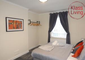 a bedroom with a bed and a window at Welsh Drive Apartment by Klass Living Blantyre in High Blantyre