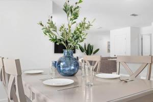 a table with plates and a blue vase on it at Springhill Retreat! 3 bed, 2 Bath! in Spring Hill