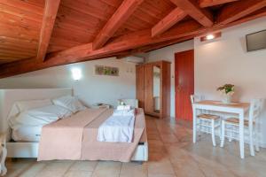 a bedroom with a bed and a table and chairs at Casa Nostra in Pula
