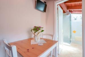 a dining room table with a vase of flowers on it at Casa Nostra in Pula