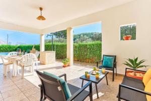 a living room with a couch and chairs and a table at Villa Oliver by Villa Plus in El Port