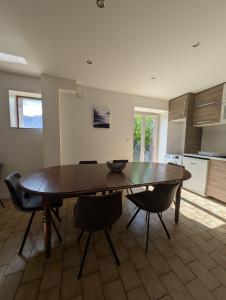 a dining room table and chairs in a kitchen at Maisonnette in Villar-Saint-Pancrace