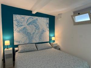 カッラーラにあるil Melograno Guest Houseのベッドルーム1室(ベッドの上に大きな絵画付)