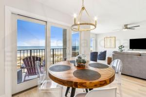 a dining room with a table and a view of the ocean at Remodeled 2 Bed/2 Bath, 3rd floor Oceanfront condo sleeps 5. Oceanfront balcony & pool. in Fernandina Beach