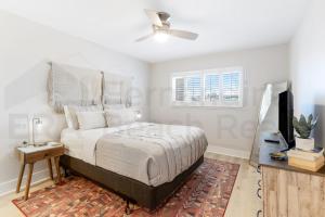 a bedroom with a large bed with a ceiling fan at Remodeled 2 Bed/2 Bath, 3rd floor Oceanfront condo sleeps 5. Oceanfront balcony & pool. in Fernandina Beach +32 photos