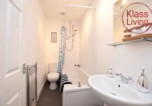 a bathroom with a sink and a toilet and a shower at Whifflet Apartment by Klass Living Coatbridge in Coatbridge