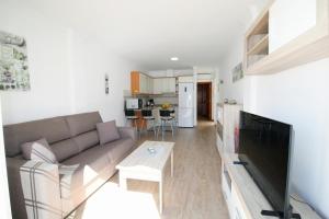 a living room with a couch and a table at Las Cascadas Puerto de Mogán II in Puerto de Mogán