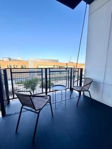 two chairs and a table on a balcony at Modern Studio Apt with Skywalk to Fiserv, Rooftop, and Parking in Milwaukee
