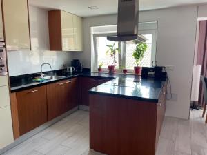 a kitchen with wooden cabinets and black counter tops at IGiDELUX in Era de Soler