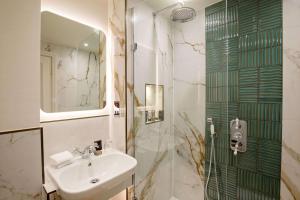 a bathroom with a sink and a shower at The Capital Hotel, Apartments & Townhouse - Small Luxury Hotels of The World in London +85 photos