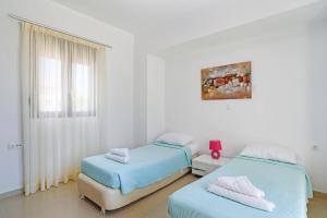 Ένα ή περισσότερα κρεβάτια σε δωμάτιο στο Villa Despina by Villa Plus +16 φωτογραφίες