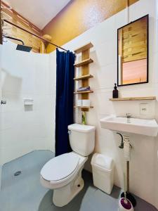 a bathroom with a toilet and a sink at Palmar la Punta 11 AC Starlink 2min walk to beach in Brisas de Zicatela +41 photos