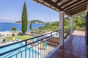 a balcony with a view of the water at Villa Annie by Villa Plus in Kassiopi