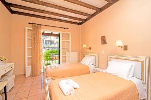 two beds in a room with a balcony at Villa Annie by Villa Plus in Kassiopi +34 photos