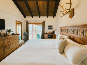 a bedroom with a large bed and a television at Ski-In & Out, Top-Floor CB Condo, Panoramic Mountain View in Crested Butte