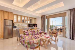 a living room with a couch and a table at Villa Chrysa by Villa Plus in Hersonissos