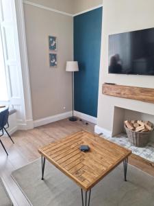 a living room with a coffee table in front of a fireplace at Annie's Place in Saltburn-by-the-Sea
