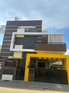 a black and yellow building with a fence at Sapthagiri Euphoria in Chikmagalūr