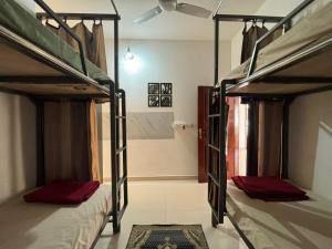 two bunk beds in a room with a bathroom at Sapthagiri Euphoria in Chikmagalūr
