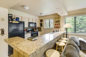 a kitchen with a large counter and a refrigerator at Walk to Sun Valley Village Condo with Deck! in Sun Valley