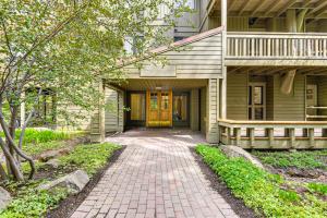a house with a brick walkway leading to the front door at Walk to Sun Valley Village Condo with Deck! in Sun Valley